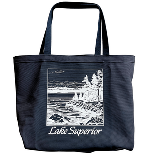 USA-Made in Washburn, Wisconsin with 100% cotton canvas. This unique tote bag; features a fun graphic designed in-house. Perfect for carrying your essentials on any adventure! Features the rocky shoreline with trees and waves in white on a dark navy blue canvas.