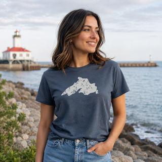 Person wearing a Lake Superior t-shirt outdoors near the water.