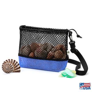 Orange and Black AdventureUs mesh collecting bag with carrying strap for agate hunting, rock collecting, mushroom foraging, and beachcombing. Filled with rocks with nature items around for featured suggested use.