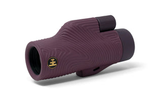 Purple monocular with a brand logo on a white background