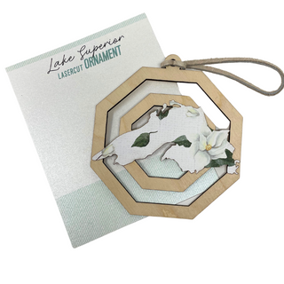 Each piece showcases unique patterns making it a one-of-a-kind addition to your holiday decor. Hang it on your tree or display it in your home to celebrate the season with a touch of nature’s artistry. Perfect as a gift or a cherished keepsake, this ornament captures the spirit of the holidays and the timeless beauty of Lake Superior.

Laser cut birch wood, measures about 3.75 in wide x 4 in tall, is strung with white leather string and packaged in a cellophane bag with backing card.&nbsp;