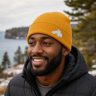 Man outside wearing an organic cotton knit hat featuring a Lake Superior embroidered patch designed and applied by AdventureUs in Washburn Wisconsin.