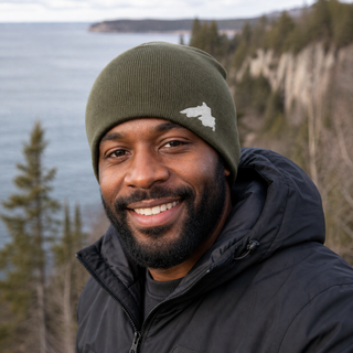 Man outside wearing an organic cotton knit hat featuring a Lake Superior embroidered patch designed and applied by AdventureUs in Washburn Wisconsin.