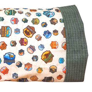 This pillowcase is a perfect gift for the National Parks enthusiast in your life.  Standard Size measures 30" x 20" One pillowcase Washing Instructions: Machine Wash Cold/Tumble Dry Low Product designed and sewn by&nbsp;AdventureUs in Northern Wisconsin  Materials: 100% cotton&nbsp;Riley Blake Designs™ National Parks Badges fabric