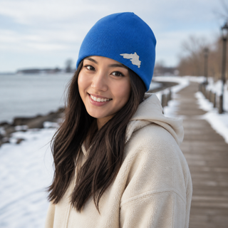 Woman outside wearing an organic cotton knit hat featuring a Lake Superior embroidered patch designed and applied by AdventureUs in Washburn Wisconsin.