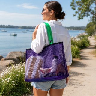Woman carrying a purple mesh tote bag with a scenic background