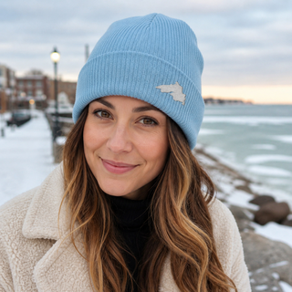 Woman outside wearing an organic cotton knit hat featuring a Lake Superior embroidered patch designed and applied by AdventureUs in Washburn Wisconsin.