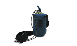 Small, versatile, and ready for more than one job, the Monocular Tube Caddy keeps your monocular protected and accessible, whether it’s slung over your shoulder, mounted to your pack, or clipped inside your car.

Featuring a drawstring cinch lid, NocLoc universal strap connectors, and rugged recycled fabric, this caddy integrates seamlessly with the NocLoc system. Bonus: it’s conveniently sized to double as a slim-can beverage holder when you’re glassing from camp or trailhead.